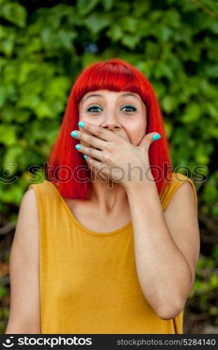 Surprised red haired woman in a park wearing yellow dress