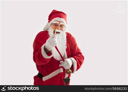 Surprised Santa Claus looking at chocolate over colored background