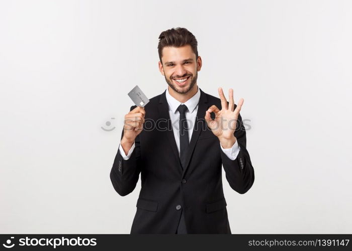 Surprised, speechless and impressed handsome caucasian businessman in classic suit showing credit card, say wow, standing white background astonished.. Surprised, speechless and impressed handsome caucasian businessman in classic suit showing credit card, say wow, standing white background astonished