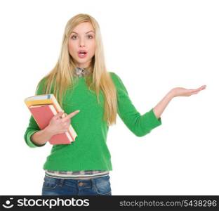Surprised student girl pointing on empty hand