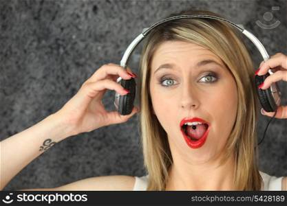 Surprised woman listening to music
