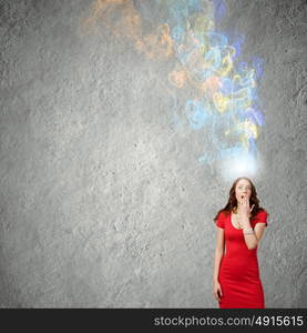 Surprised woman. Young emotional pretty woman in red dress