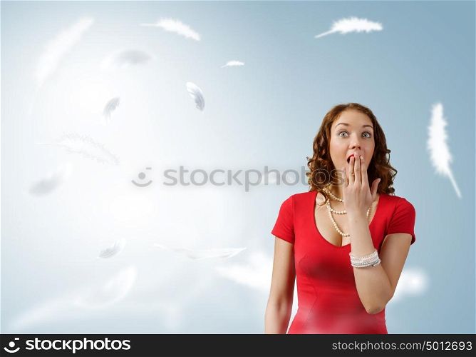 Surprised woman. Young emotional pretty woman in red dress