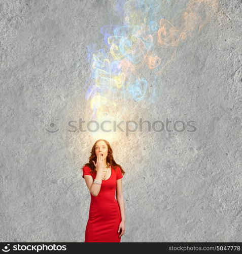 Surprised woman. Young emotional pretty woman in red dress