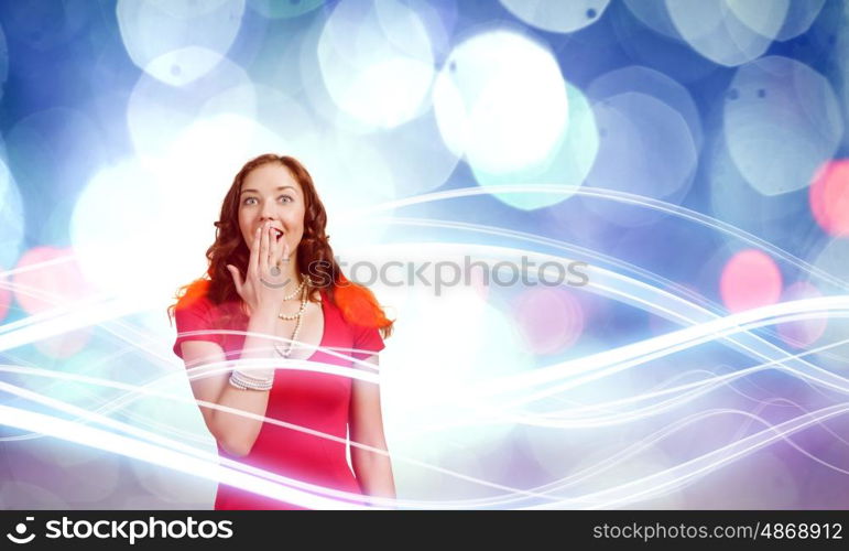 Surprised woman. Young pretty woman in red dress against bokeh background