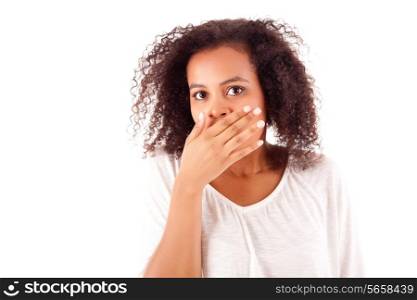 Surprised young african woman with hands over her mouth