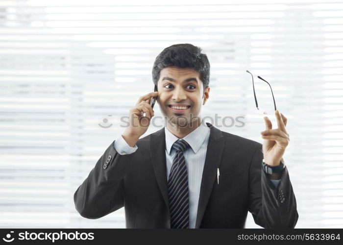 Surprised young businessman on call