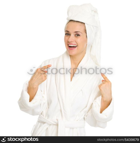 Surprised young woman in bathrobe pointing on herself