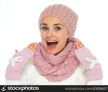 Surprised young woman in knit scarf, hat and mittens