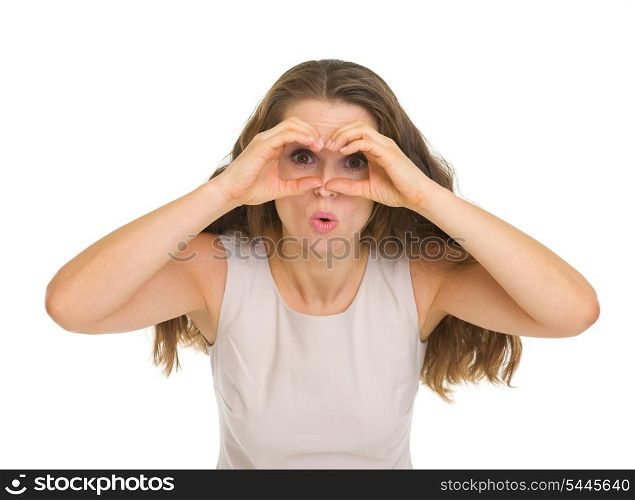 Surprised young woman looking through binoculars shaped hands
