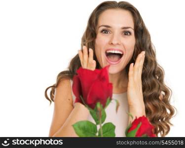 Surprised young woman receiving red roses