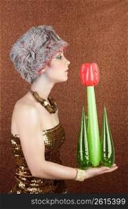 surreal fashion futuristic woman holding plastic tulip red flower