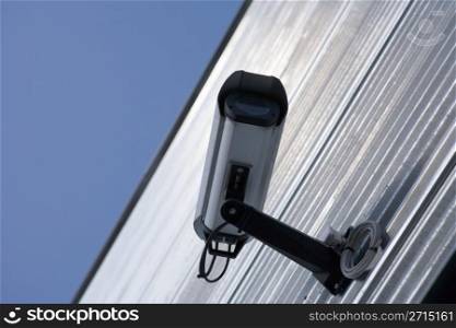 Surveillance video camera attached on a wall of a building