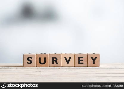 Survey sign made of blocks on a wooden table