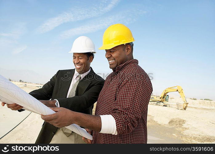 Surveyor and Construction Worker on Site