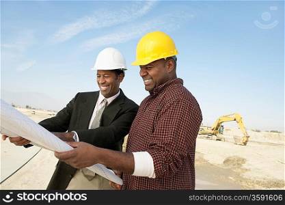 Surveyor and Construction Worker on Site
