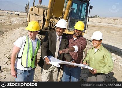 Surveyor and construction workers on site