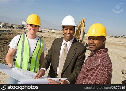 Surveyor and construction workers on site, portrait