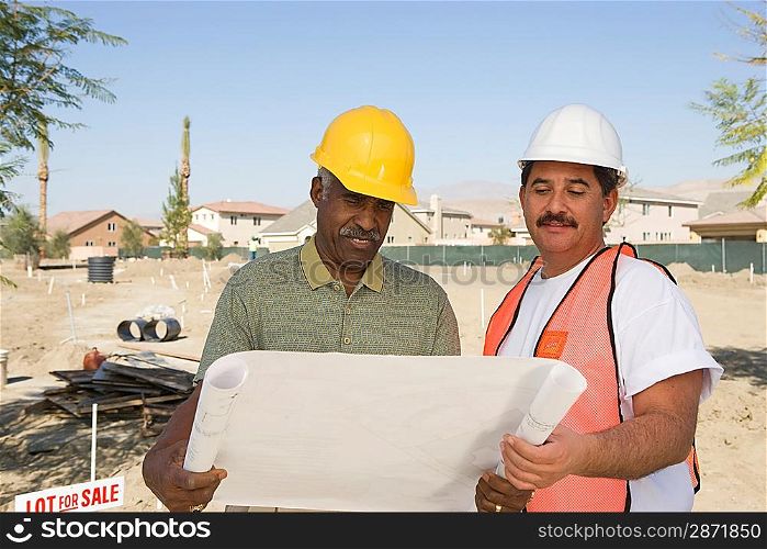 Surveyor and contraction worker at construction site