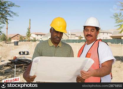 Surveyor and contraction worker at construction site