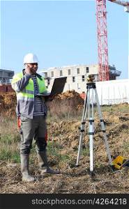 Surveyor on site with a laptop