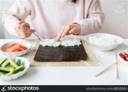 Sushi cooking process, girl makes sushi with different flavors. Sushi cooking process, girl makes sushi with different flavors.