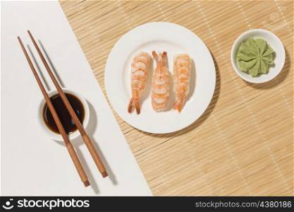 sushi day concept with wasabi chopsticks