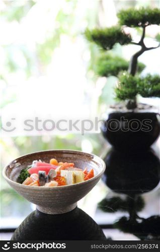 Sushi don , raw salmon tuna octopus and egg on rice