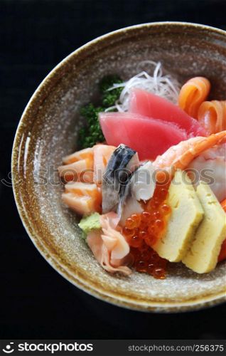Sushi don , raw salmon tuna octopus and egg on rice