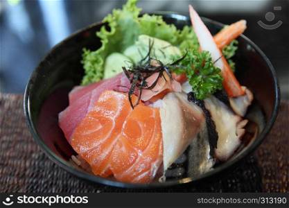 Sushi don , raw salmon tuna octopus on rice