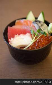 Sushi don , raw salmon tuna octopus on rice