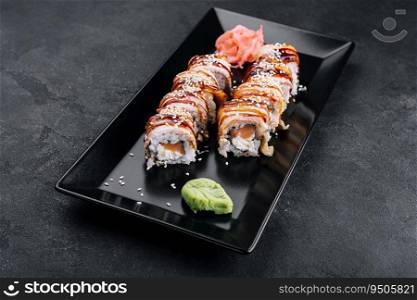 Sushi eel roll maki on black plate