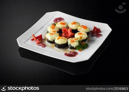 sushi in a white plate on a dark background with reflection. sushi in a plate on a black background