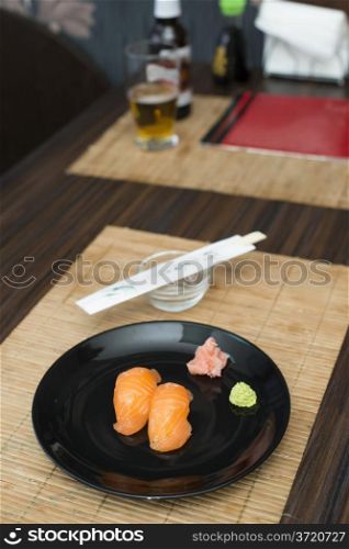 Sushi in sushi bar. Table and ration sushi with salmon