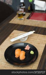 Sushi in sushi bar. Table and ration sushi with salmon