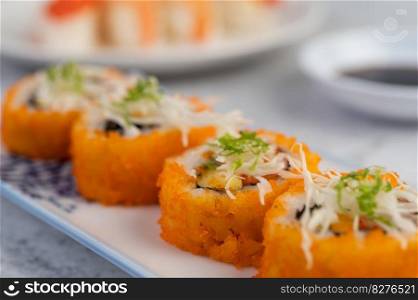 Sushi is beautifully arranged on the plate.
