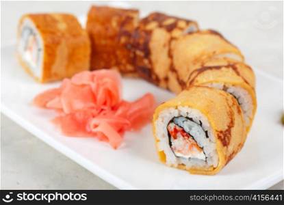 Sushi - made of crab meat, cheese, omelette outside