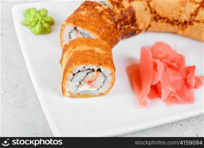 Sushi - made of crab meat, cheese, omelette outside