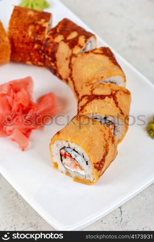 Sushi - made of crab meat, cheese, omelette outside