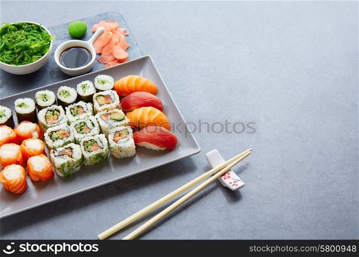 Sushi Maki and Niguiri California roll with seaweed chuka salad soy sauce and wasabi
