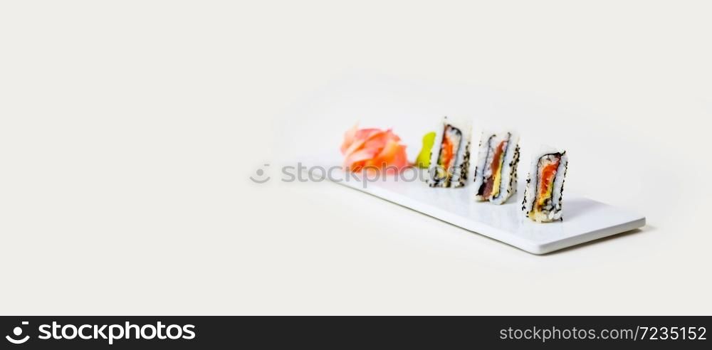 Sushi on a white plate on a white background isolated