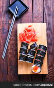 sushi on tray and on a table