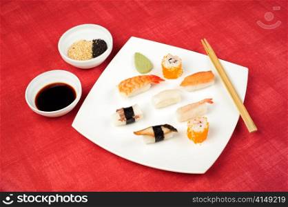 sushi plate. assorted sushi lying at the white square plate