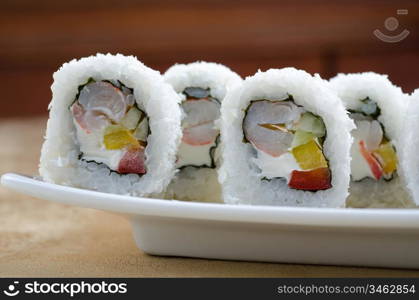 sushi roll of shrimp, cucumber, pepper and sauce, closeup