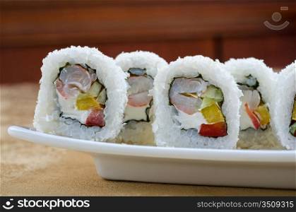 sushi roll of shrimp, cucumber, pepper and sauce, closeup