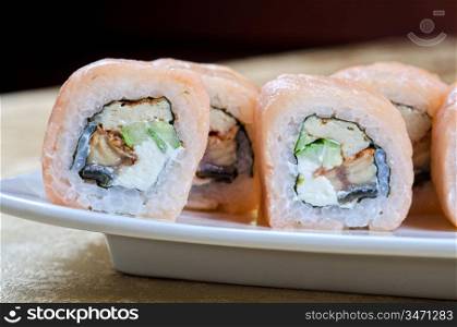 sushi roll of shrimp, eel, cucumber, pepper and sauce