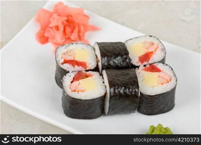 Sushi rolls made of crab meat, cheese, and tomato