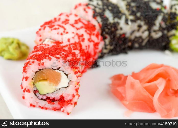 Sushi rolls made of fish avocado and different flying fish roe (tobiko caviar)