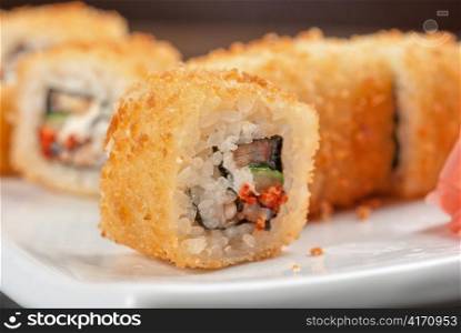 Sushi rolls made of rice, smoked eel, cream cheese and flying fish roe - tobiko caviar