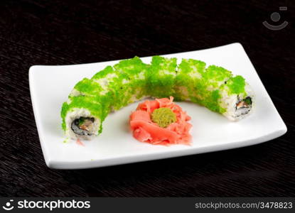 Sushi rolls made of salmon, avocado, flying fish roe - tobiko caviar and philadelphia cheese